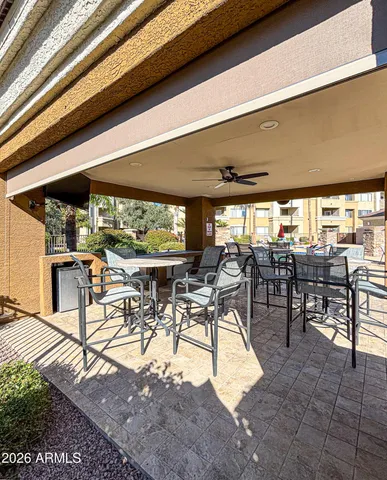 a view of a patio with table and chairs