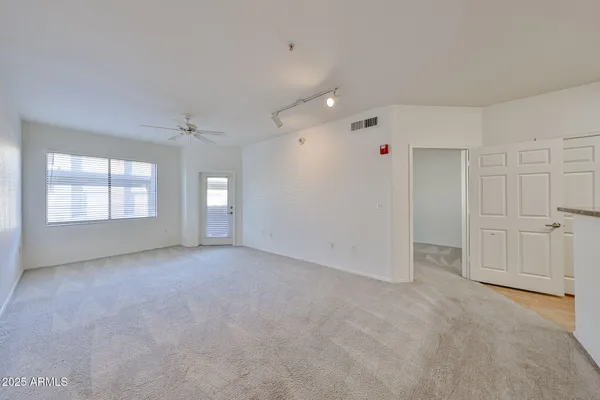 an empty room with windows and closet