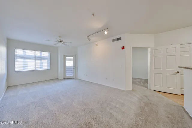 an empty room with windows and closet