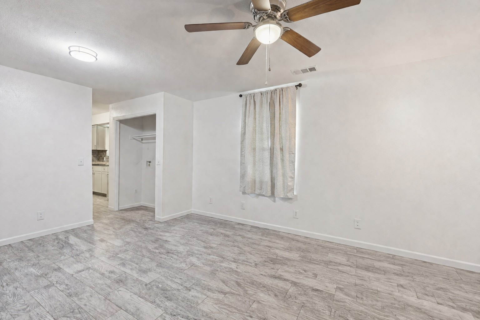 200 Monterrey Street, Unit A & B Elgin, TX 78621 - Photo 3 of 32 Living room view of kitchen and in unit laundry. 200 Monterrey, Elgin, TX 78621
