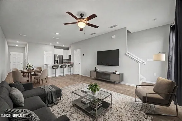 a spacious bedroom with a bed and a potted plant