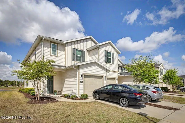a living room with furniture wooden floor and a large window