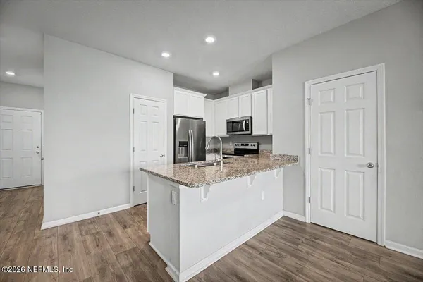 a bedroom with a bed and a potted plant