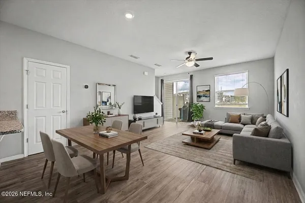 a bathroom with a granite countertop toilet a sink and a mirror