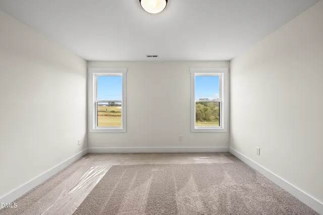 a bathroom with double vanity sinks and a mirror