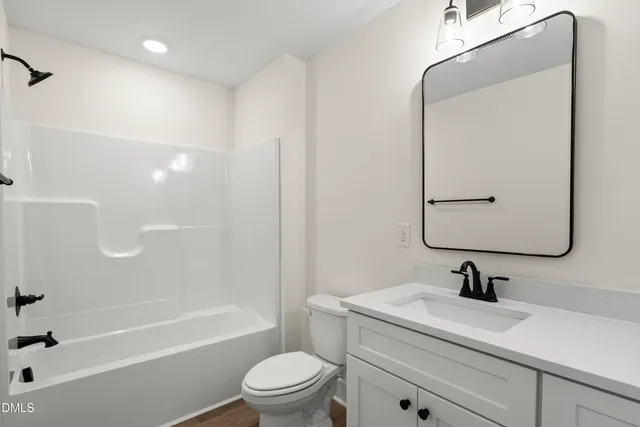 a view of a livingroom with a ceiling fan and window