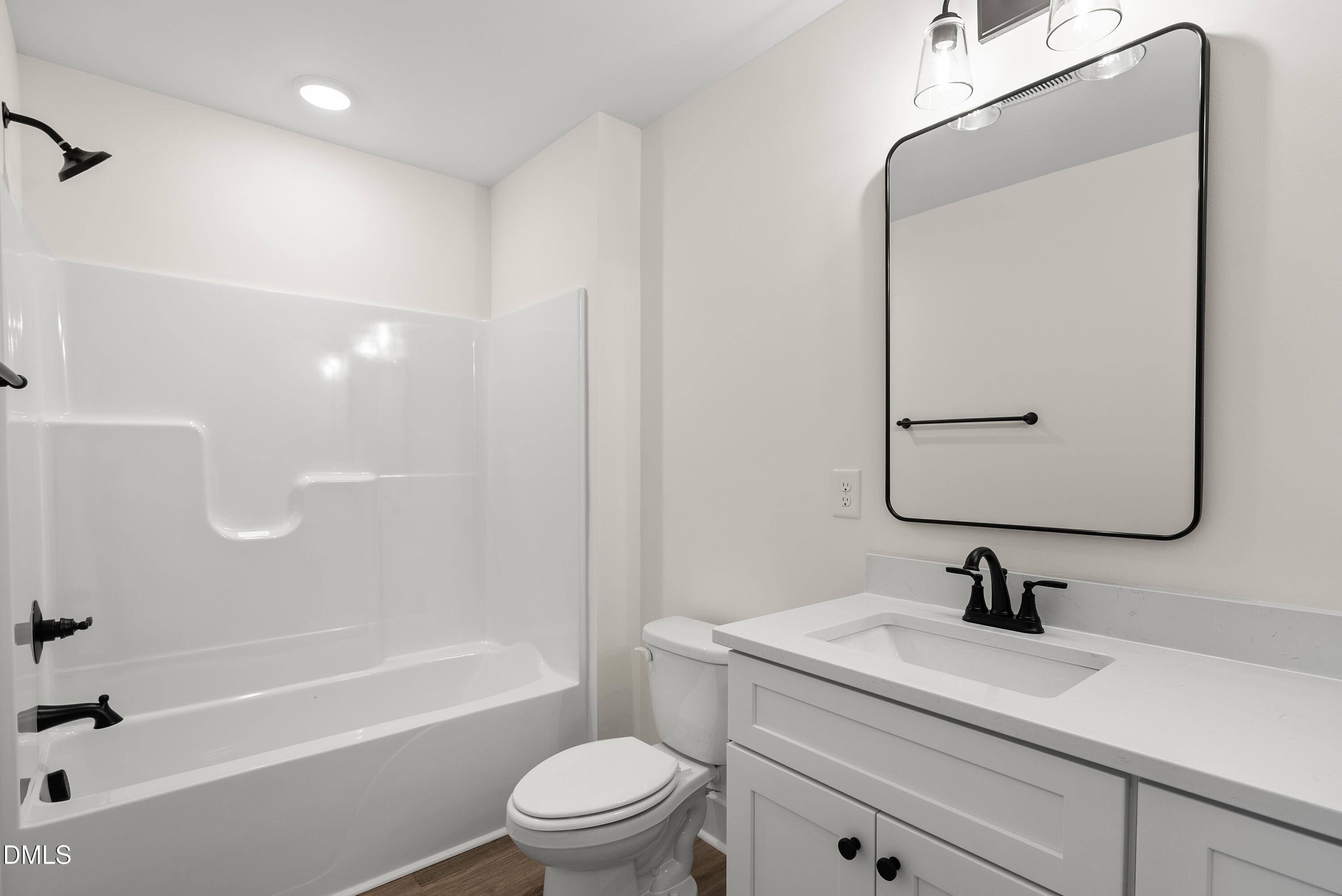 6786 Fire Tower Road Spring Hope, NC 27882 - Photo 23 of 30 a bathroom with a sink a toilet and a mirror