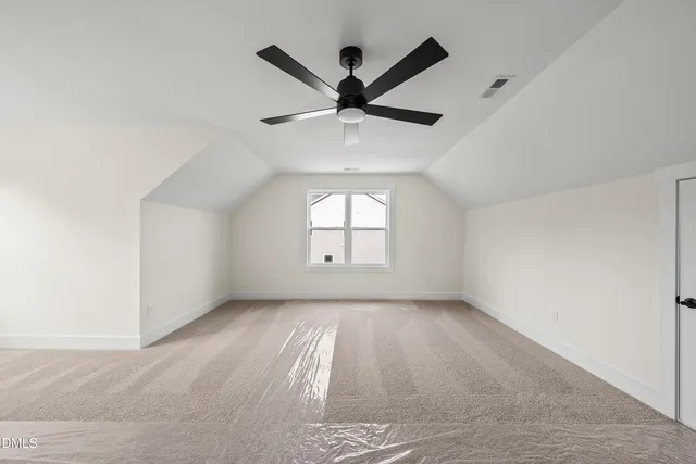 a view of a livingroom with a ceiling fan and window