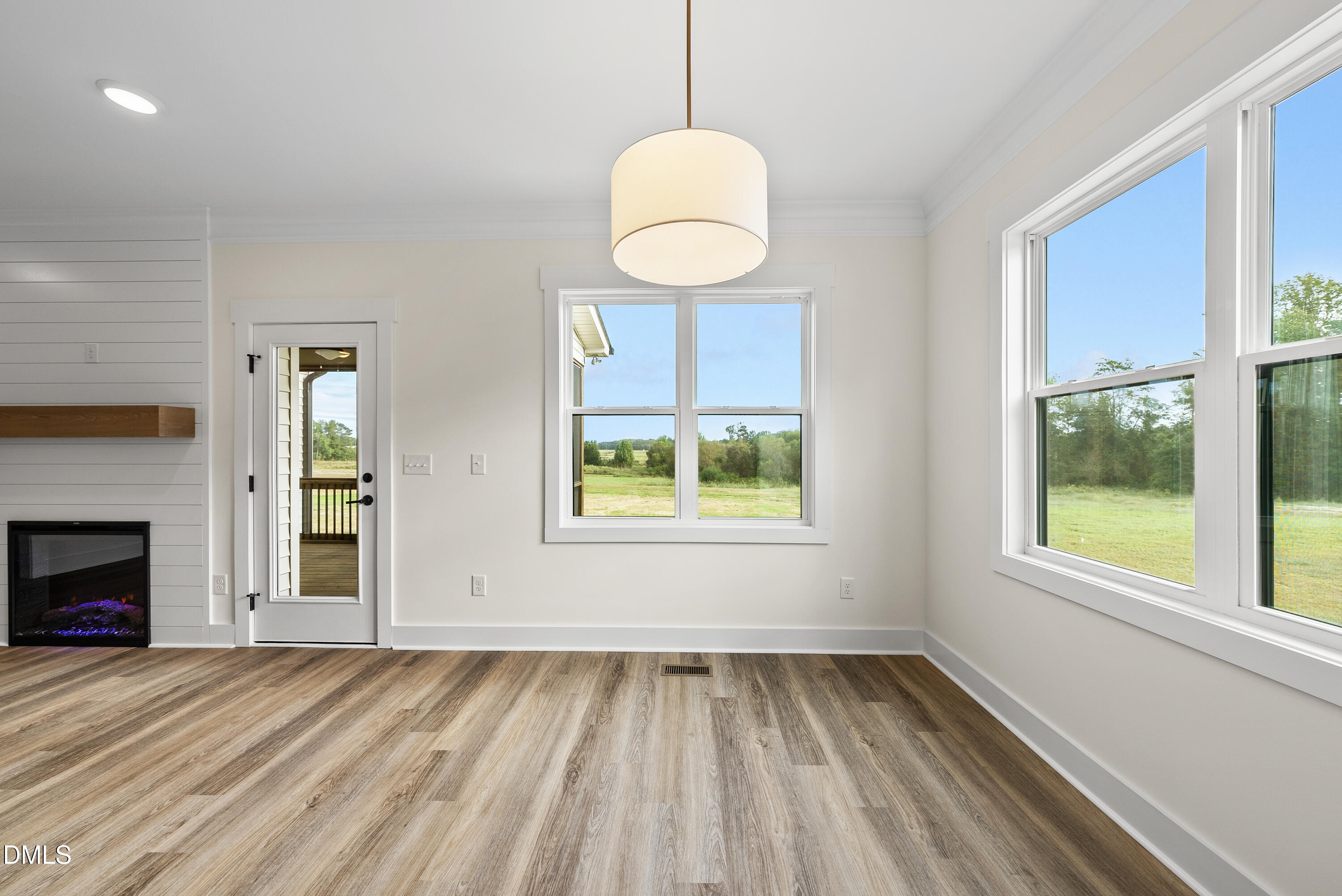 6786 Fire Tower Road Spring Hope, NC 27882 - Photo 10 of 30 a view of an empty room with wooden floor and a window