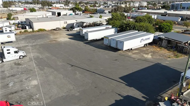 a view of a patio with table and chairs potted plants with wooden floor and fence