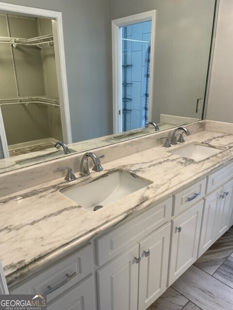 839 Sandy Creek Road Fayetteville, GA 30214 - Photo 14 of 22 a bathroom with a granite countertop sink and a mirror