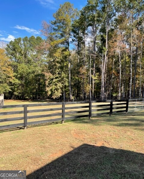 839 Sandy Creek Road Fayetteville, GA 30214 - Photo 20 of 22 a view of outdoor space with swimming pool and trees in the background