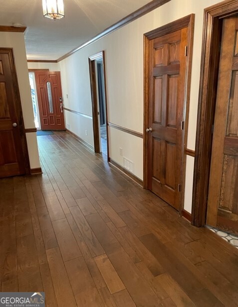 839 Sandy Creek Road Fayetteville, GA 30214 - Photo 6 of 22 a view of a hallway with wooden floor and stairs