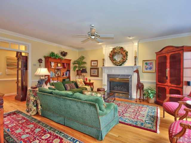 9437 Macon Road Raleigh, NC 27613 - Photo 11 of 25 Room features crown molding, chair railing, ceiling fan, fireplace, recessed lighting and hardwoods. Den/Family/Great Room