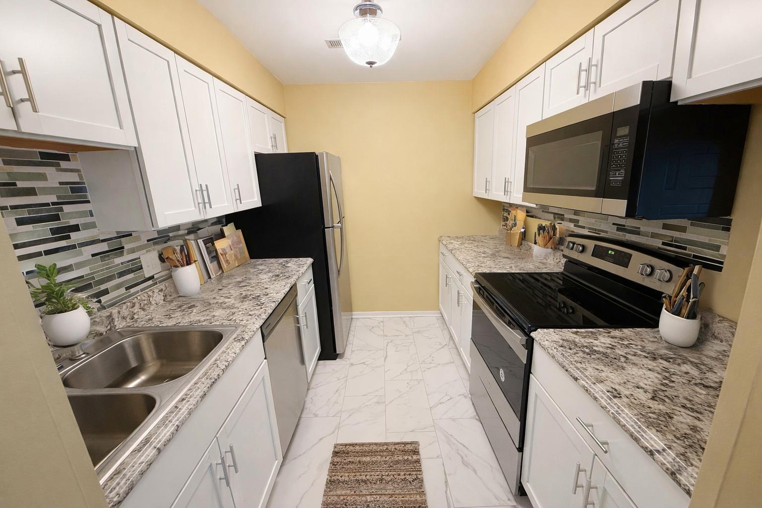 1462 Stonebridge Circle, Unit F10 Wheaton, IL 60189 - Photo 6 of 19 a kitchen with a stove and a microwave