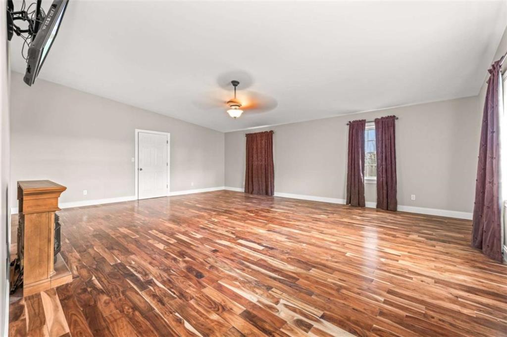 131 Caudell Drive Lula, GA 30554 - Photo 28 of 58 a view of a room with wooden floor and ceiling fan