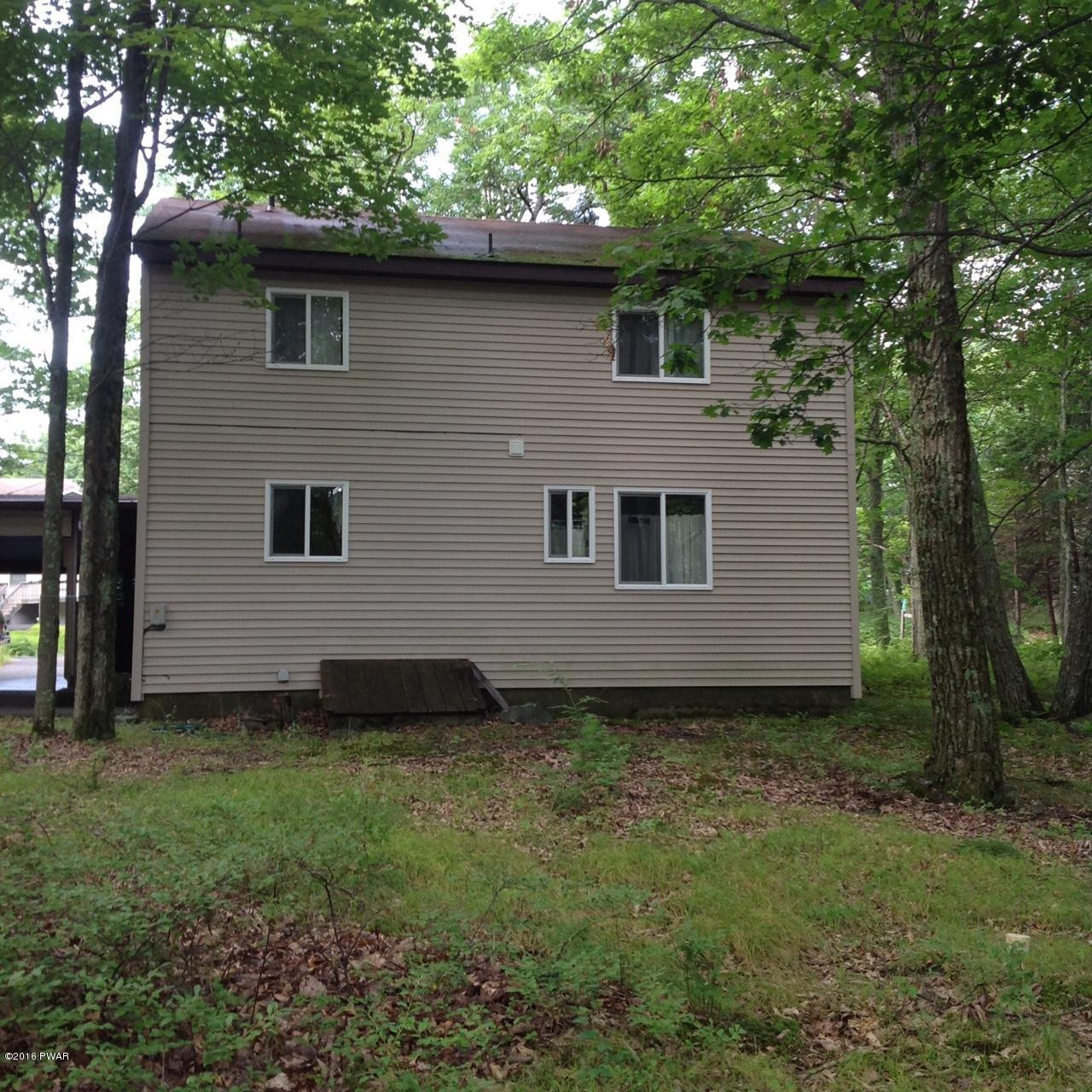 222 Maple Ridge Drive Hawley, PA 18428 - Photo 2 of 19 a view of a backyard with plants and large tree