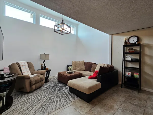 a living room with furniture a rug and a flat screen tv