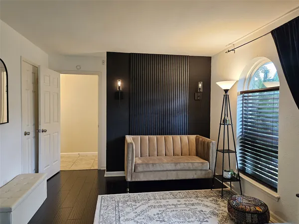 a living room with a couch and a walk in closet
