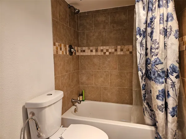 a bathroom with a toilet and shower