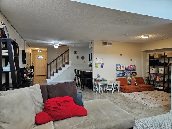 a living room with furniture toys and a flat screen tv