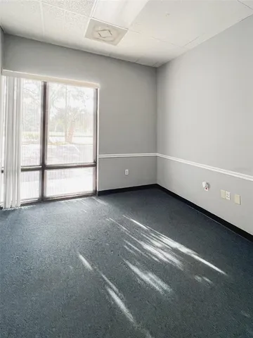 a outdoor space with the couches and dining table with the garden view