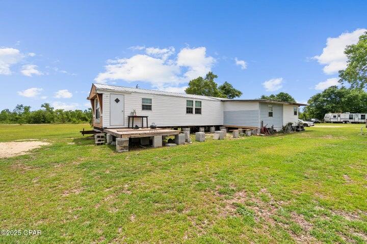 261 Hero Road Chipley, FL 32428 - Photo 1 of 1 a backyard of a house with table and chairs