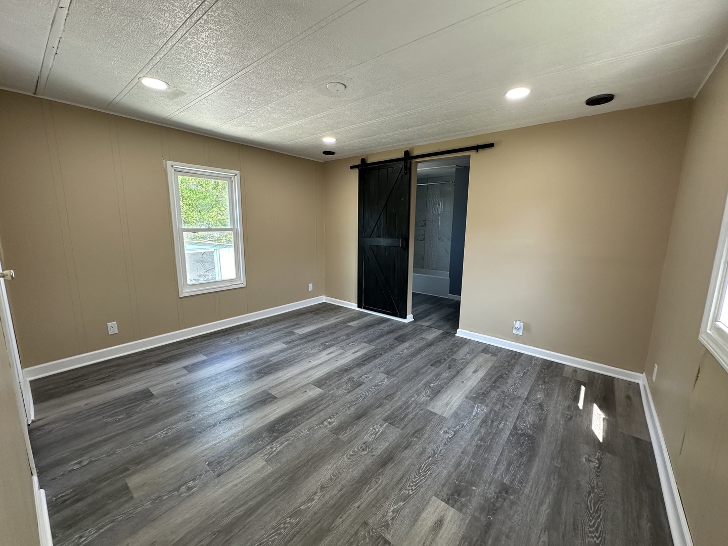 180 North Windmere Circle Matteson, IL 60443 - Photo 14 of 32 an empty room with wooden floor and windows