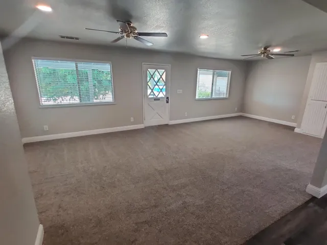 a view of a kitchen with a sink and a refrigerator