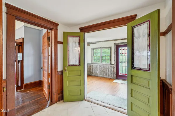 a view of a hallway with wooden floor