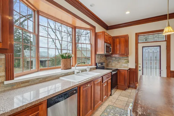 a bathroom with a sink vanity granite toilet and a mirror