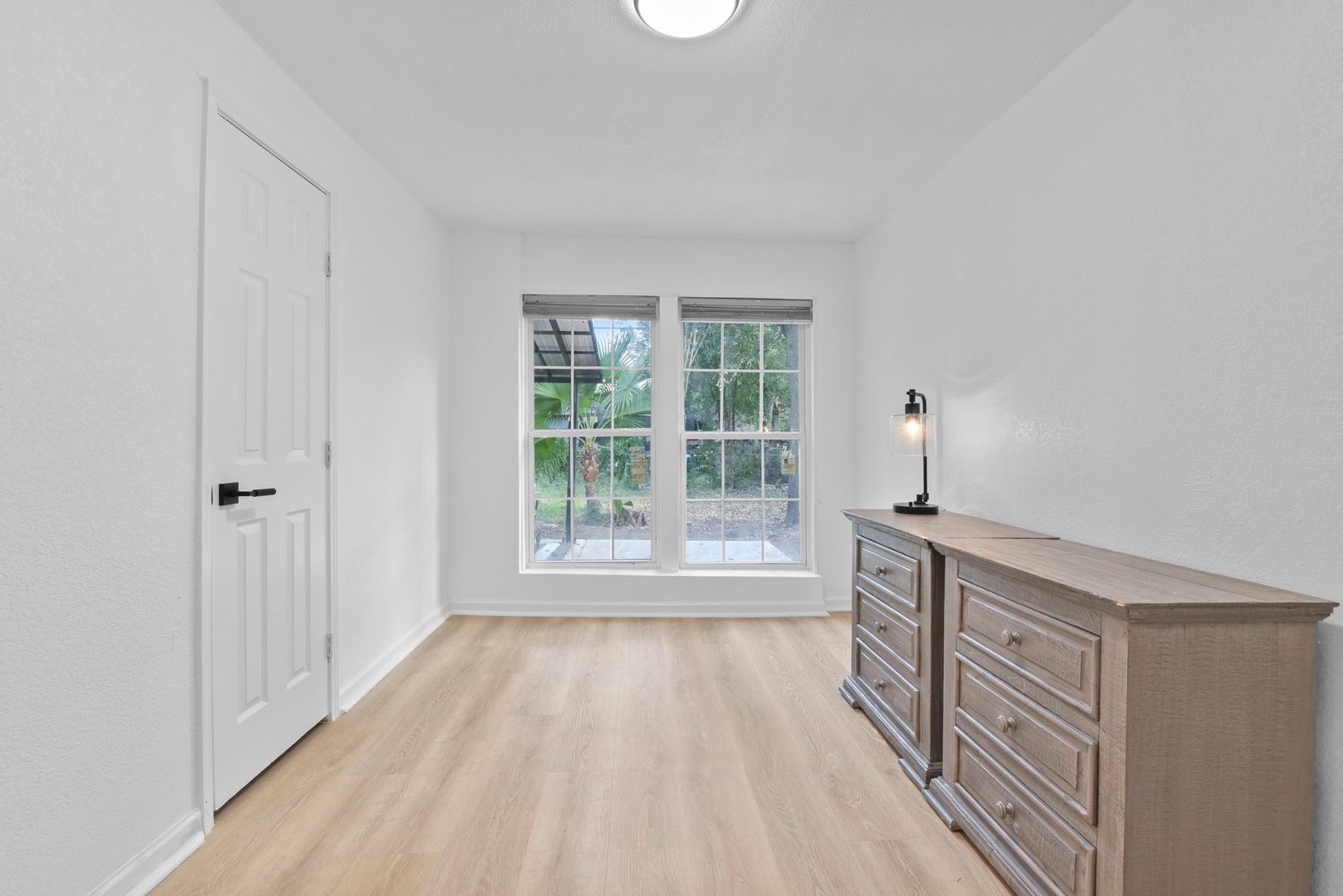5530 Malmedy Road Houston, TX 77033 - Photo 12 of 23 a view of wooden floor and cabinets in a room