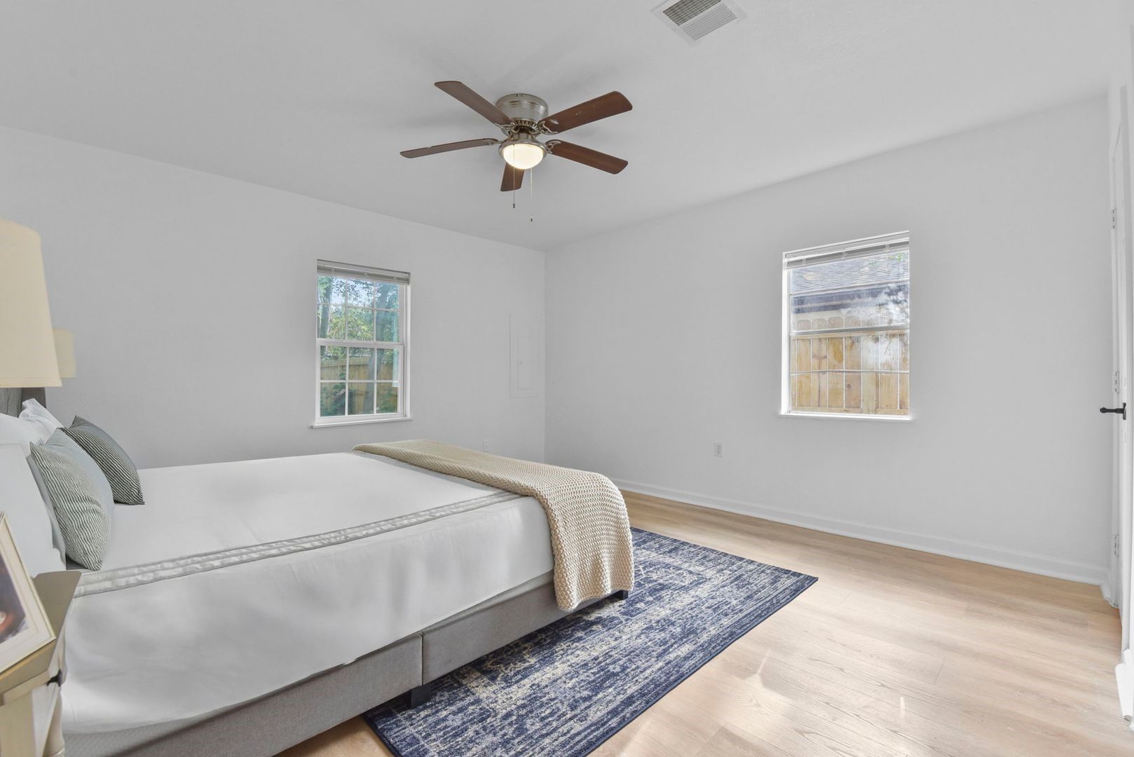 5530 Malmedy Road Houston, TX 77033 - Photo 15 of 23 a bed sitting in a bedroom next to a window