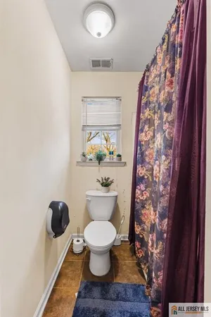 a bathroom with a toilet and a shower