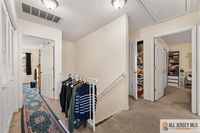 a view of a hallway with seating area