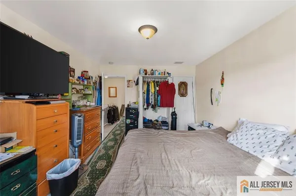 a bedroom with bed and flat screen tv