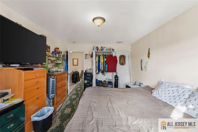 a bedroom with bed and flat screen tv