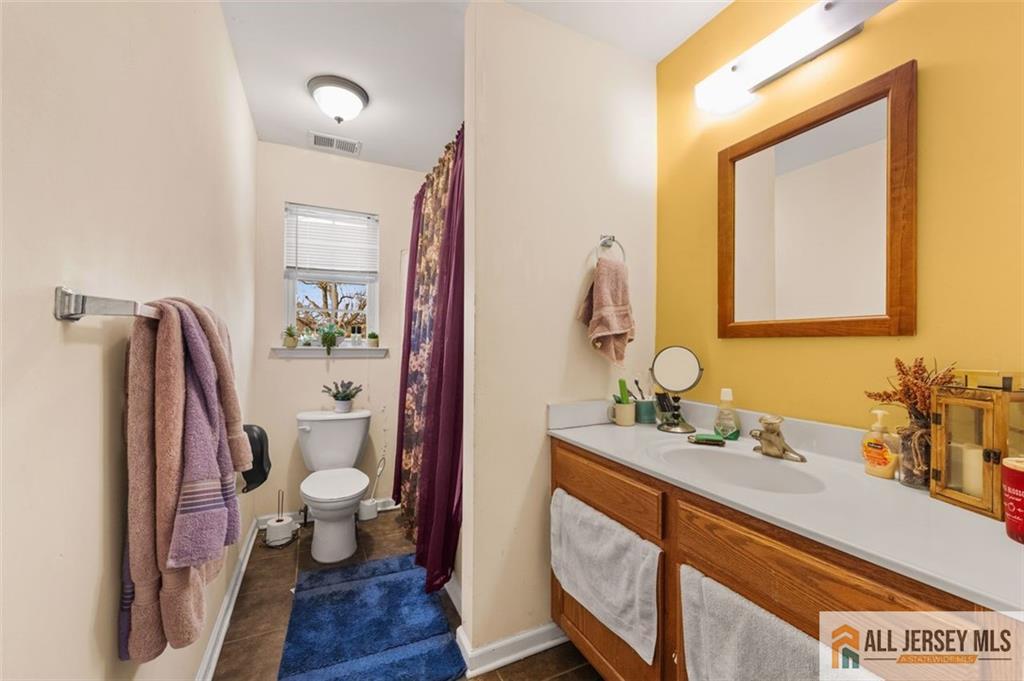 643 Drake Avenue Middlesex, NJ 08846 - Photo 23 of 28 a bathroom with a granite countertop toilet sink and mirror