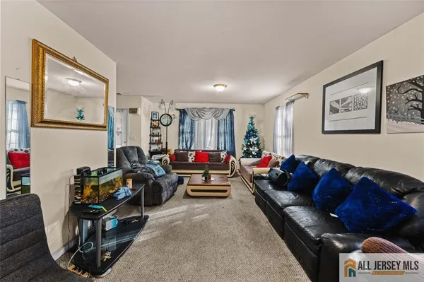 a living room with furniture and a mirror