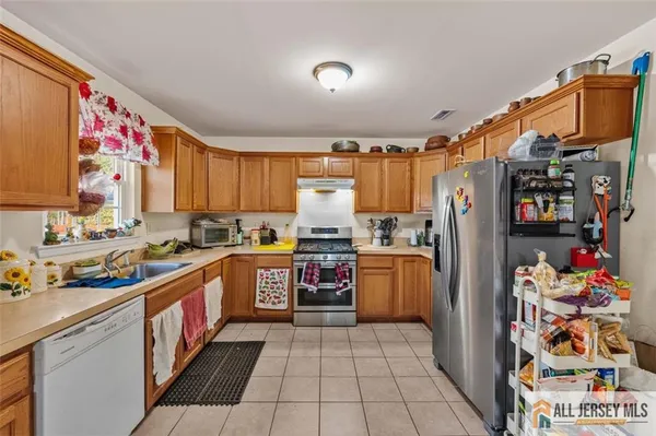 a kitchen with refrigerator and cabinets
