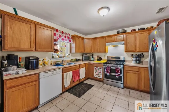 a kitchen with stainless steel appliances granite countertop a refrigerator sink and cabinets