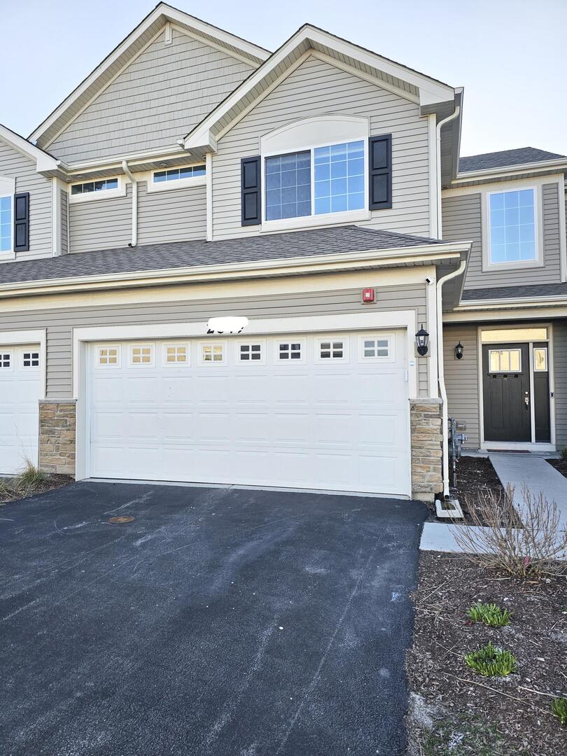 a view of a house with backyard and parking space