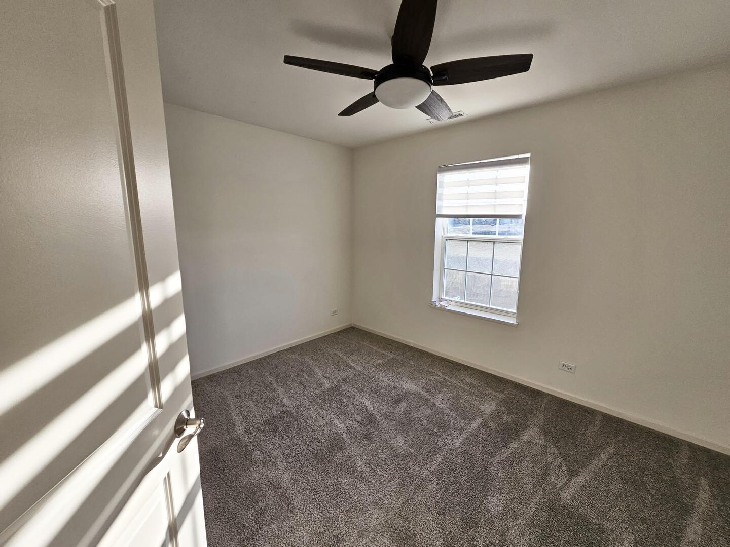 2049 Stuttle Road Batavia, IL 60510 - Photo 11 of 14 an empty room with windows and fan