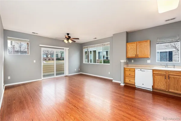 a view of a kitchen with wooden floor and a window