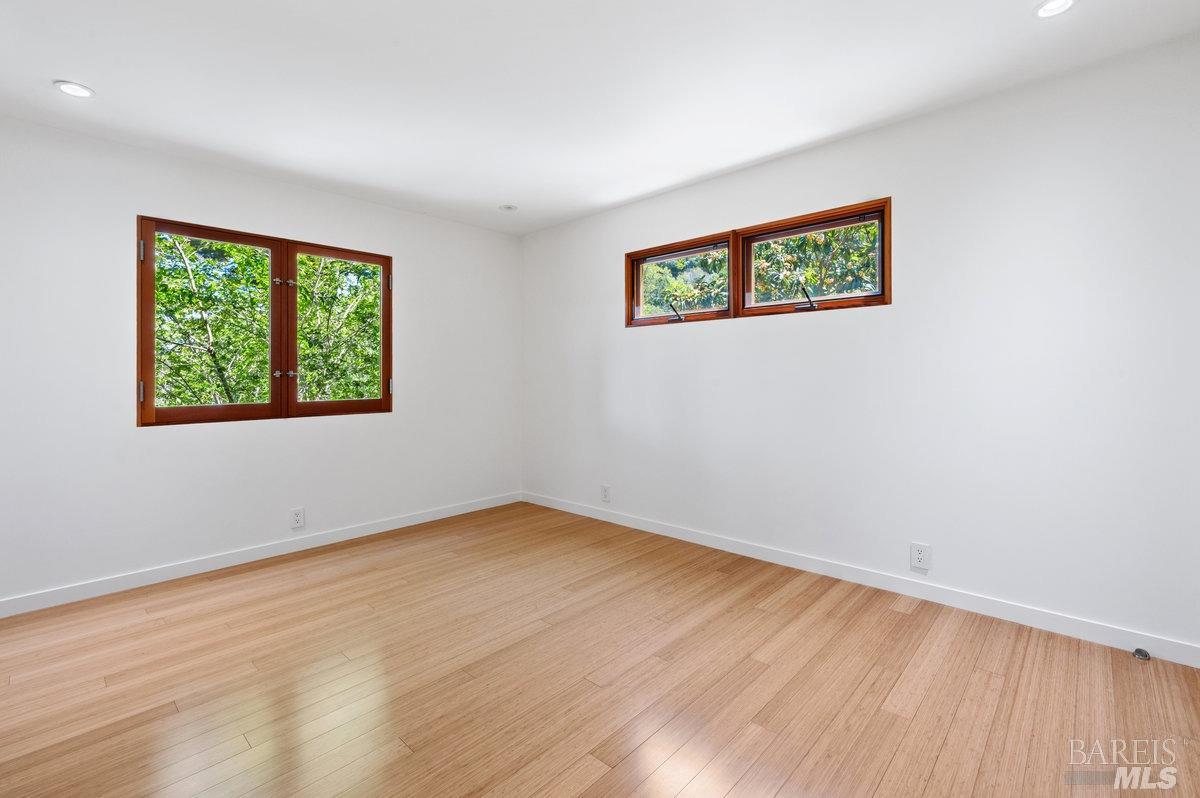 216 Reed Street Mill Valley, CA 94941 - Photo 7 of 17 a view of an empty room with wooden floor and a window