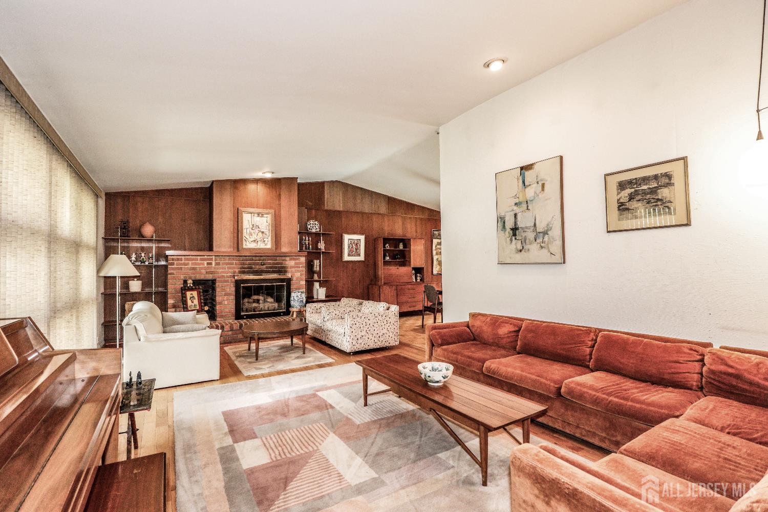 12 Buchanan Road Metuchen, NJ 08840 - Photo 6 of 42 a living room with furniture a fireplace and a flat screen tv