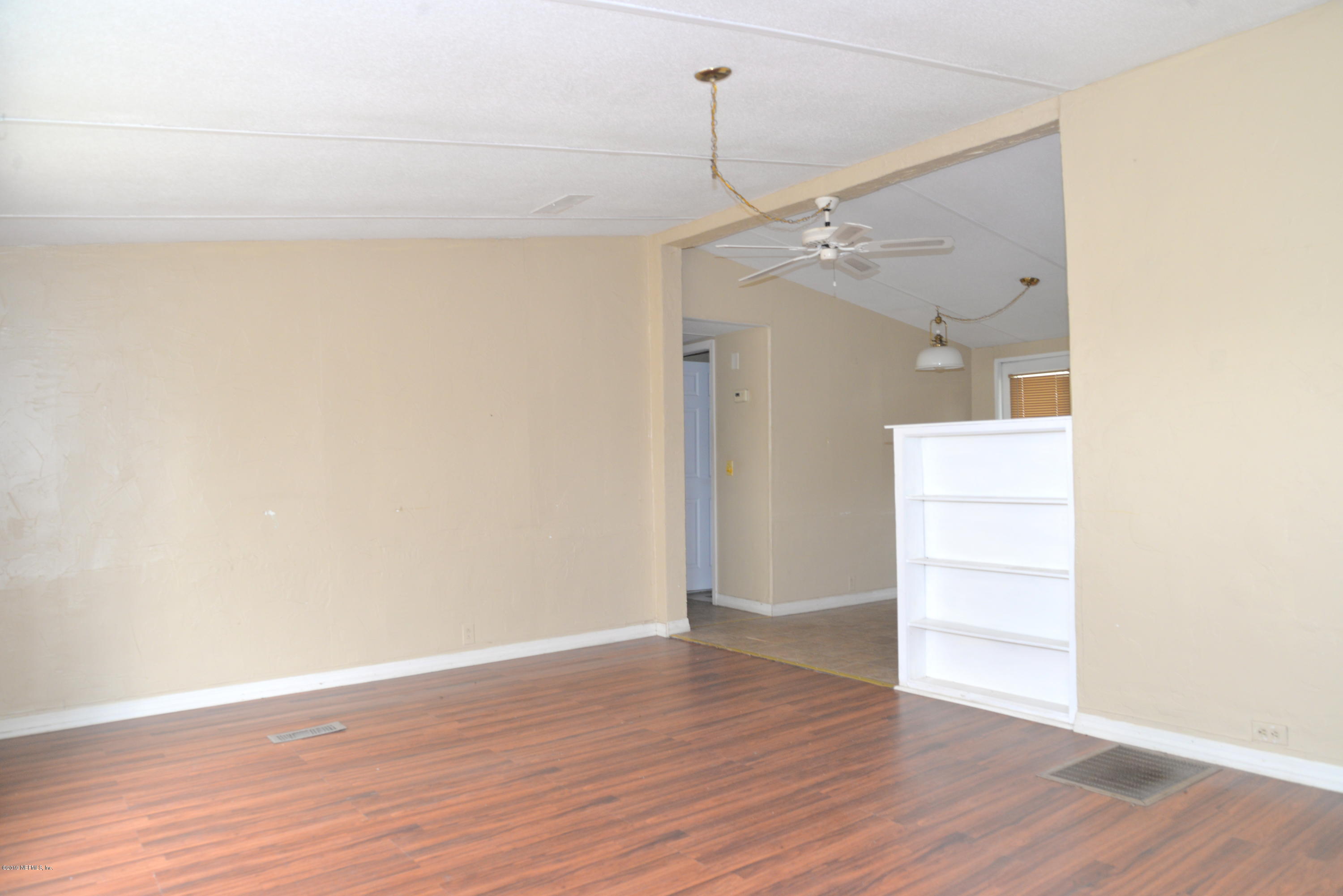 3148 Tindall Farms Road St. Augustine, FL 32084 - Photo 8 of 31 a view of a room with wooden floor and white walls