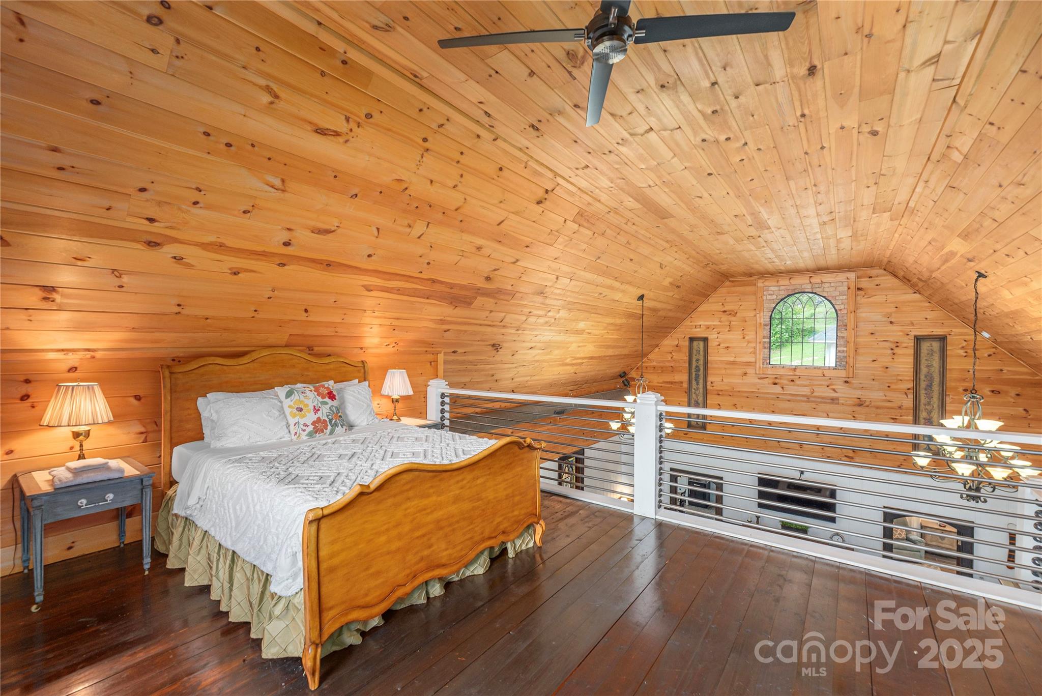 1202 Iron Duff Road Waynesville, NC 28785 - Photo 16 of 42 a bedroom with a bed and a table