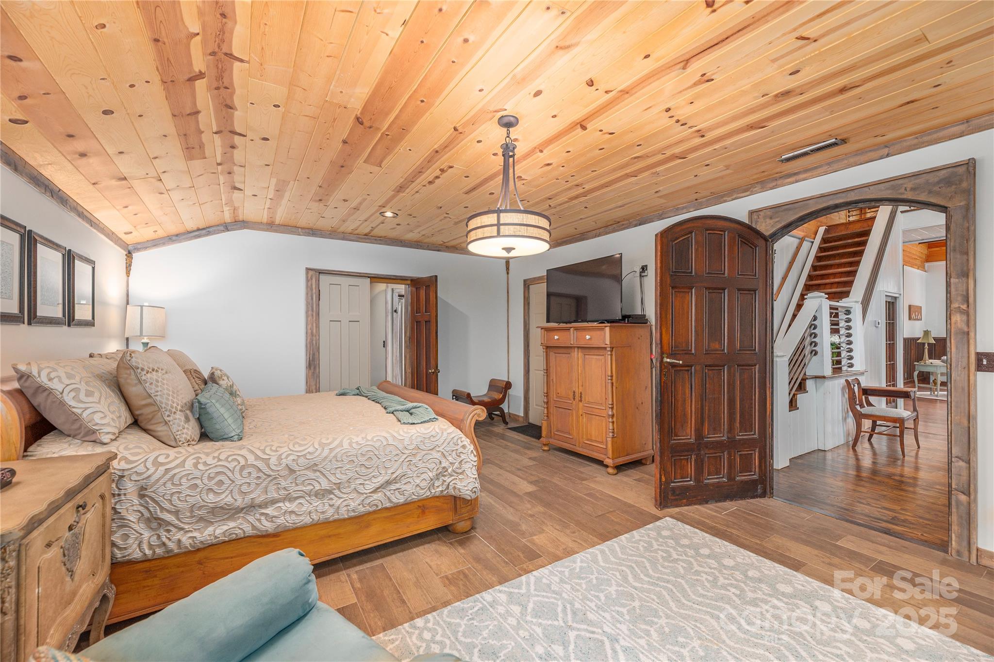 1202 Iron Duff Road Waynesville, NC 28785 - Photo 24 of 42 a spacious bedroom with a bed dresser and a window