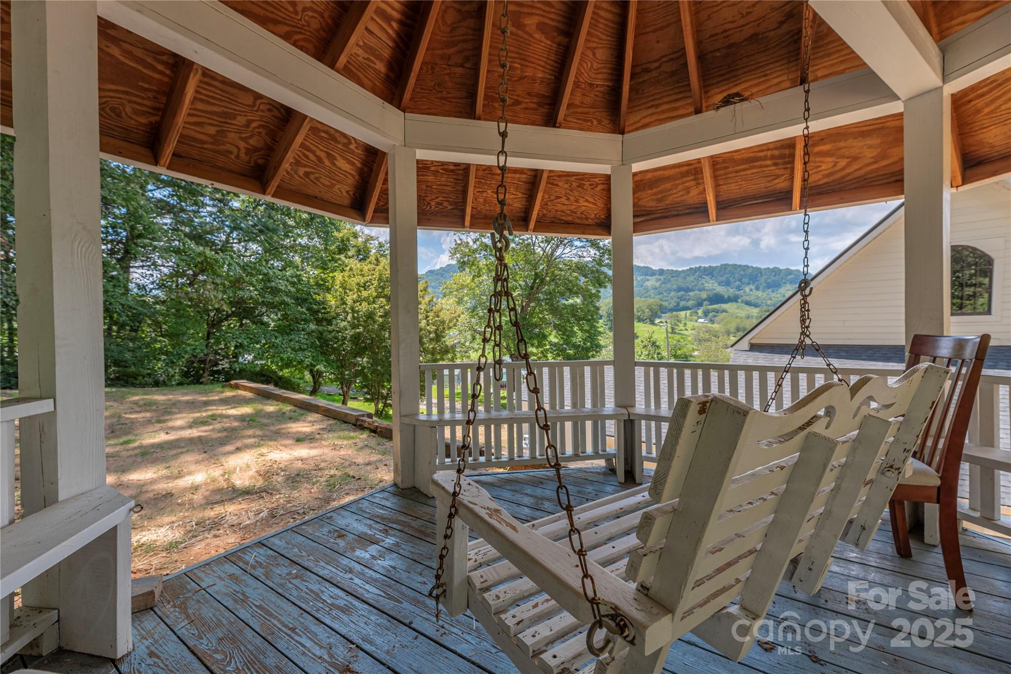 1202 Iron Duff Road Waynesville, NC 28785 - Photo 36 of 42 a view of a balcony with wooden floor and outdoor seating